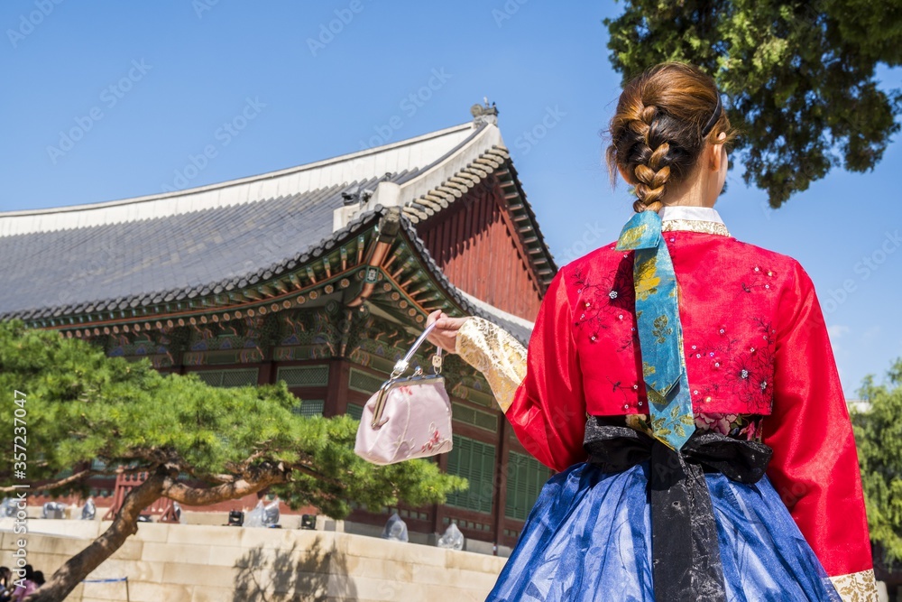 Woman in traditional Korean clothing in front of a pagoda Woman in traditional Korean clothing in front of a pagoda