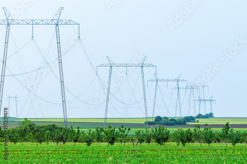 High-Voltage power line, Green Fields, Small Hills Countryside photo