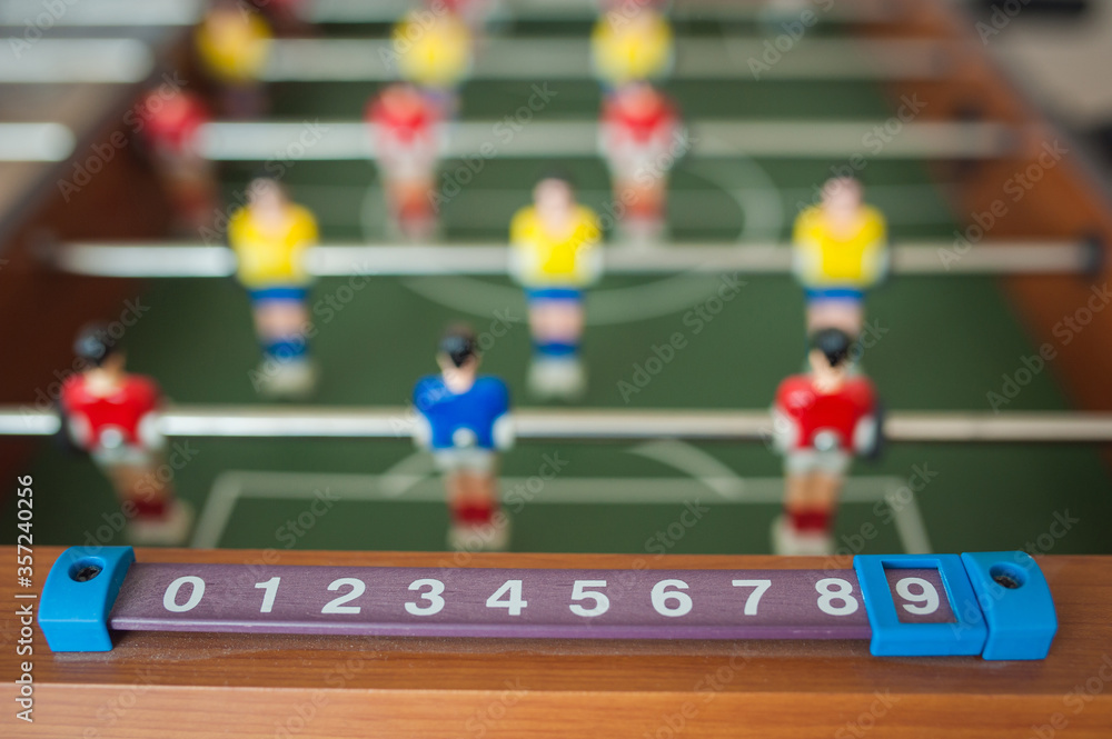 Children play table football in a children's room, close-up
