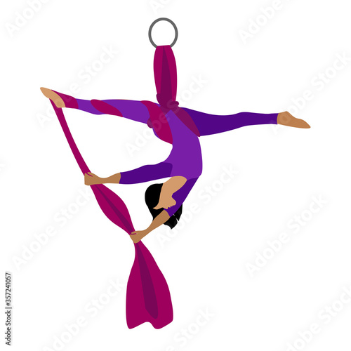 A young girl practices yoga with a ribbon or hammock. Aerial Yoga. Stretching exercises.