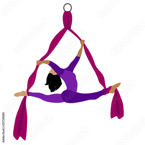 A young girl practices yoga with a ribbon or hammock. Aerial Yoga. Stretching exercises.