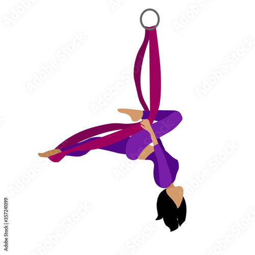 A young girl practices yoga with a ribbon or hammock. Aerial Yoga. Stretching exercises.