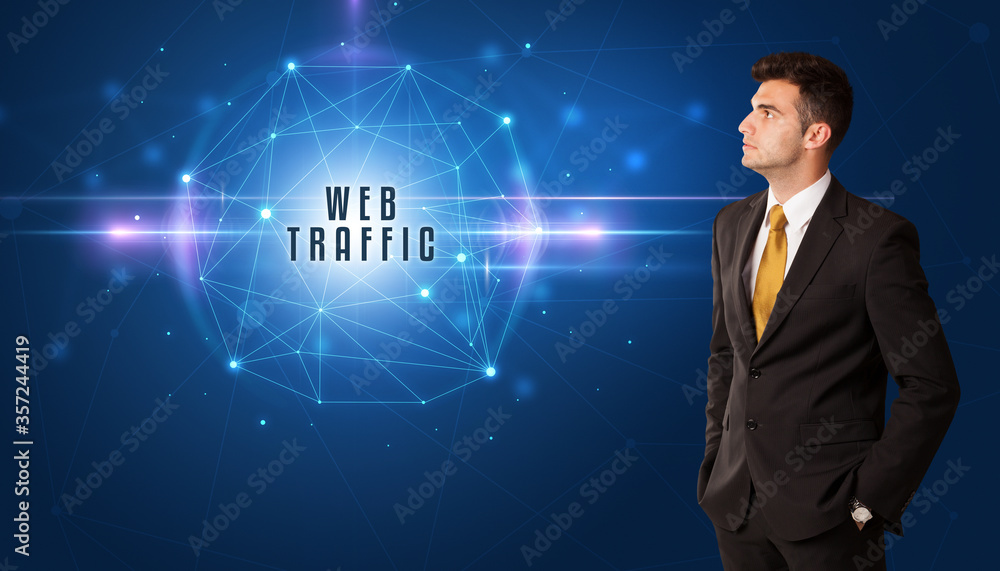 Businessman thinking about security solutions with WEB TRAFFIC inscription Businessman thinking about security solutions with WEB TRAFFIC inscription