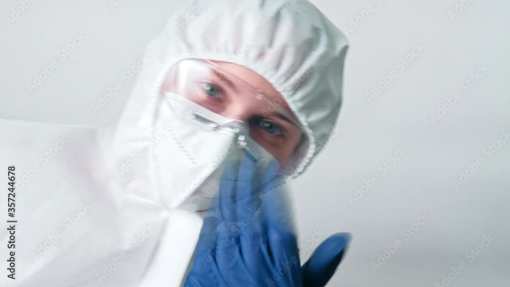Healthcare specialist. Coronavirus test. Female physician in white ppe face mask inviting patient. Healthcare specialist. Coronavirus test. Female physician in white ppe face mask inviting patient.