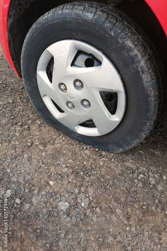 Car flat tire, closeup. Car breakdown on the road. Tire service. © NataliaSavilova