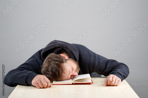 the man fell asleep with his head on the book