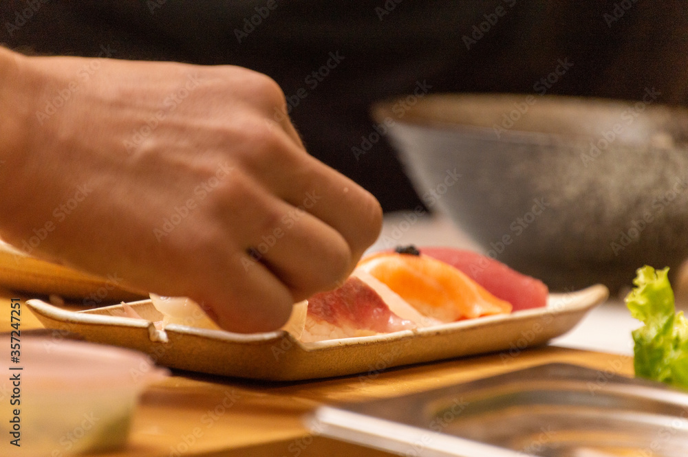 Making Japanese food with hands, raw fish sushi with fish eggs