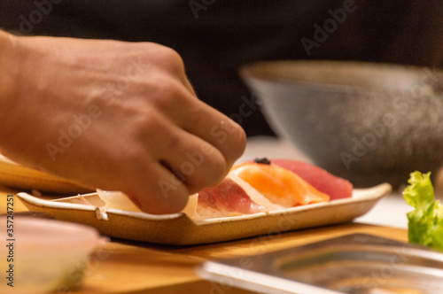 Making Japanese food with hands, raw fish sushi with fish eggs