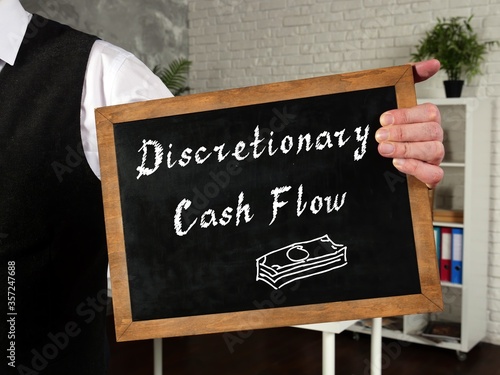 Financial concept meaning Discretionary Cash Flow with inscription on the piece of paper.