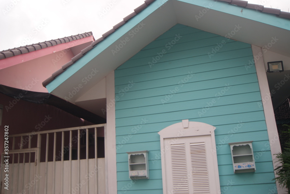 Fototapeta premium A colorful wooden house looks from the side