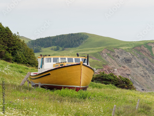 Abandoned yellow fisherman boat in a meadow, Magdalen Islands