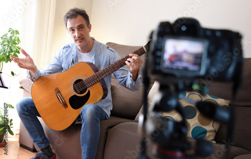 Video Blogger doing review of a guitar recording at home