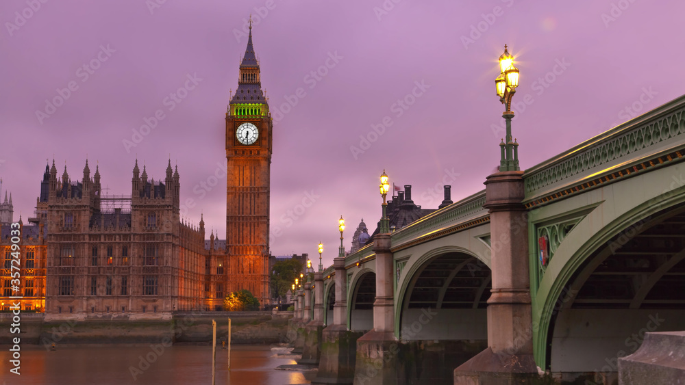 Big Ben in London during sunset as the lights glow.