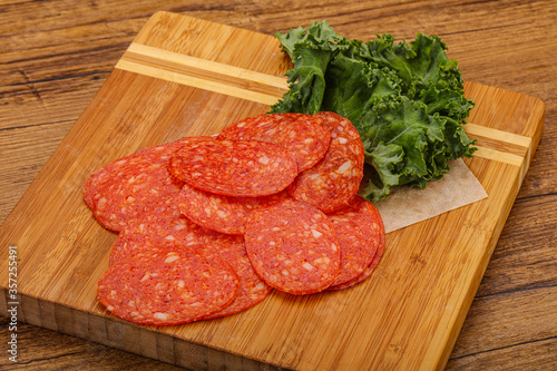 Italian spycy pepperoni sausage slices photo