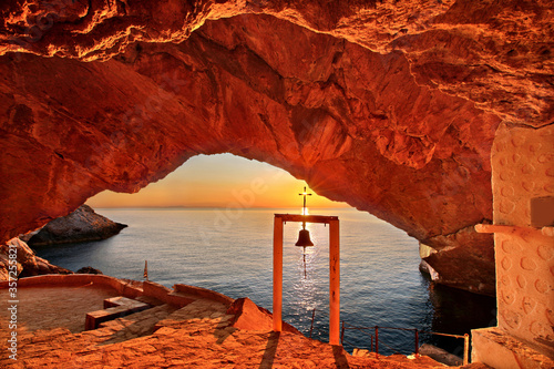 SYROS ISLAND, GREECE.
Sunset at the cave of the church of Agios Stefanos, close to Galissas village. photo