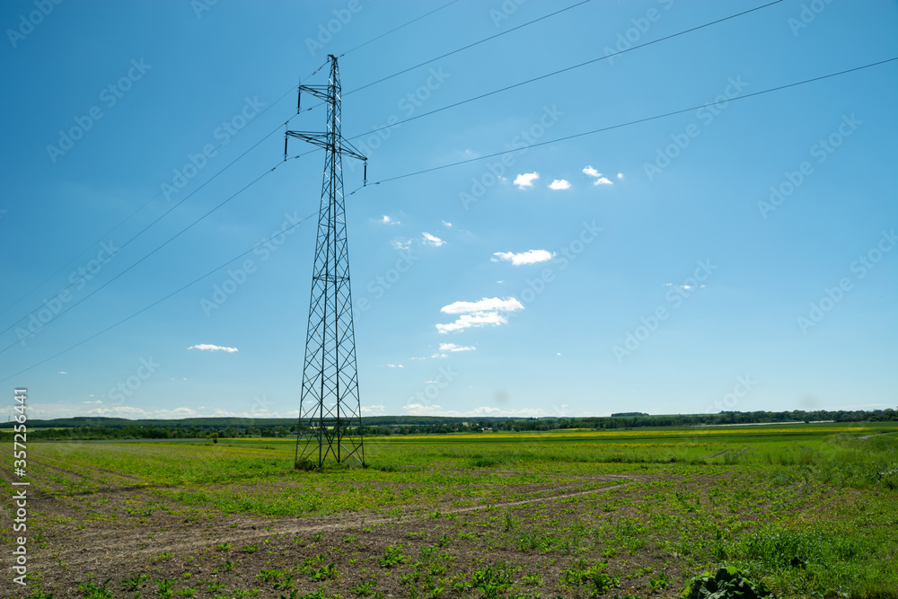 Electric pole in the field and blue sky