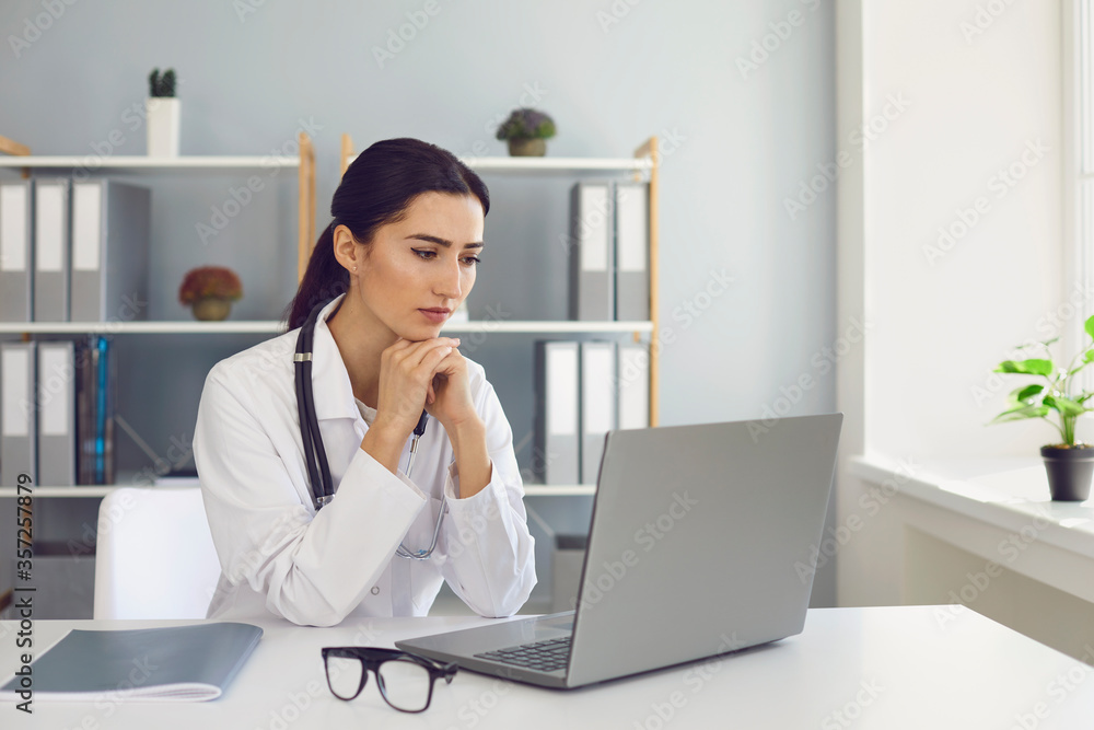 Doctor talking with patient through web using laptop computer in hospital. Telemedicine and online client counseling Doctor talking with patient through web using laptop computer in hospital. Telemedicine and online client counseling