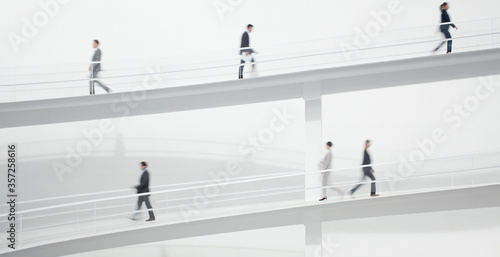 Business people walking along elevated walkway
