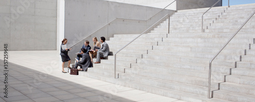 Business people meeting on concrete steps photo