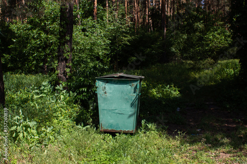 large trash can in the forest