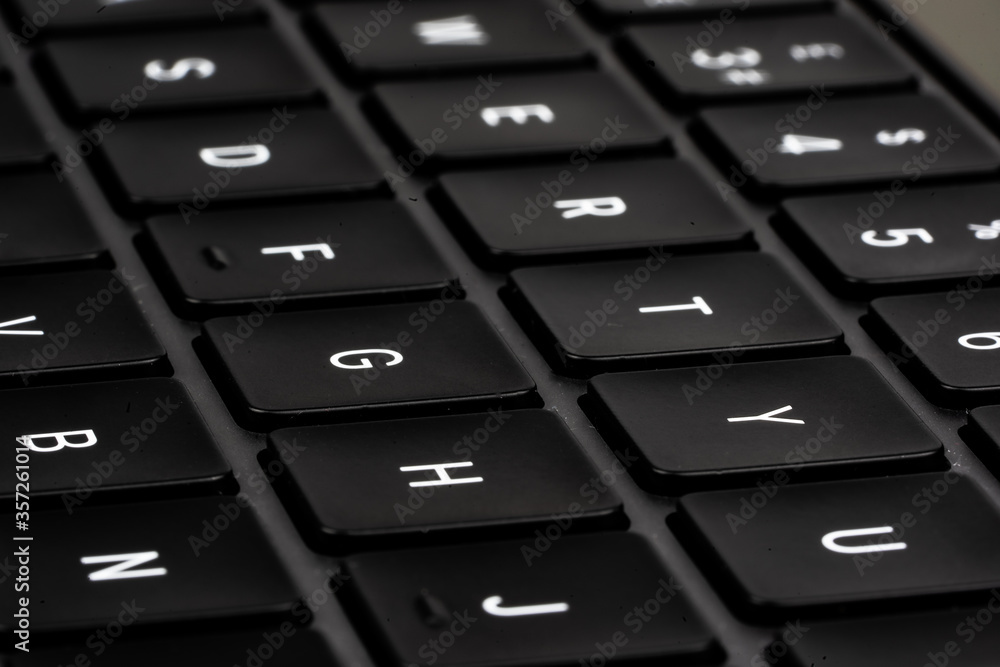Modern laptop computer close up of a black keyboard. Business Modern laptop computer close up of a black keyboard. Business