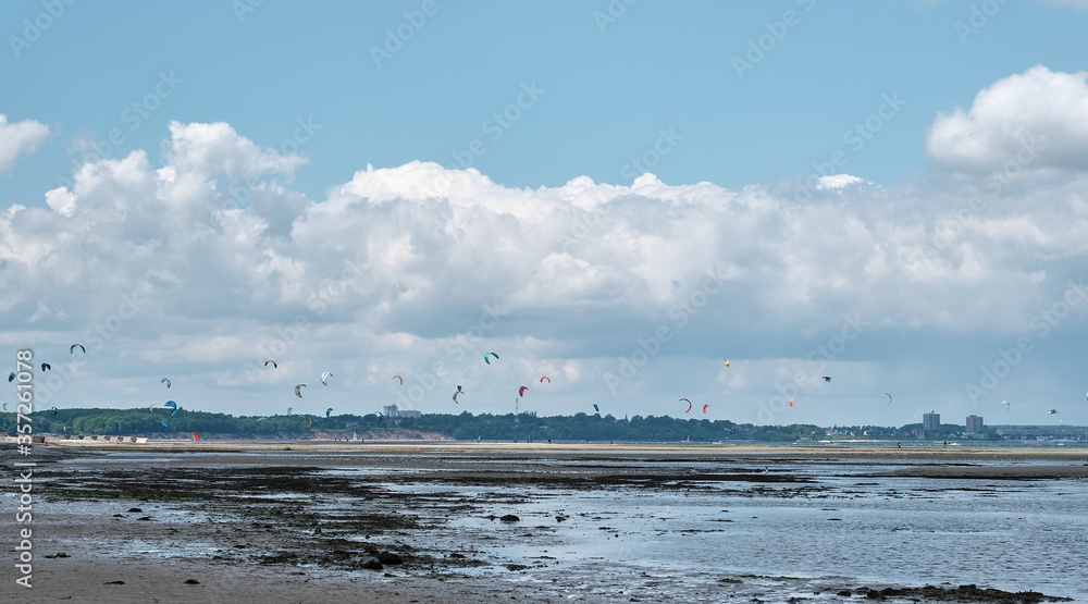 windsurfer board with kitesurfing in the background windsurfer board with kitesurfing in the background