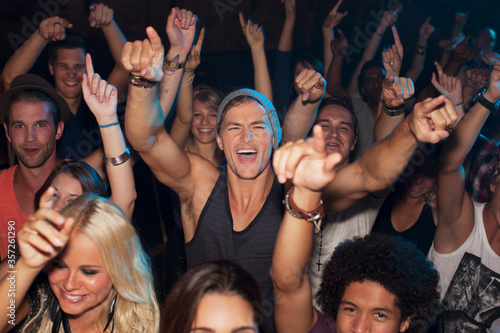 Enthusiastic man cheering in crowd at concert photo