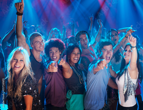 Portrait of enthusiastic crowd on dance floor of nightclub