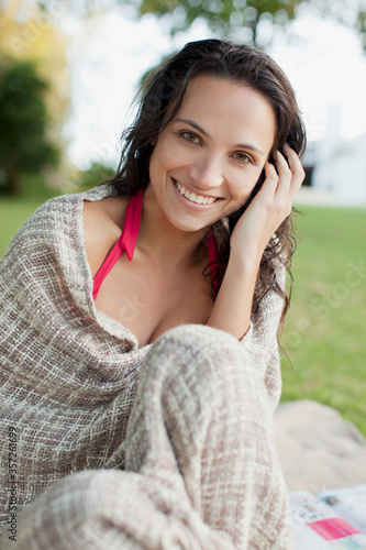 Close up portrait of smiling woman wrapped in blanket