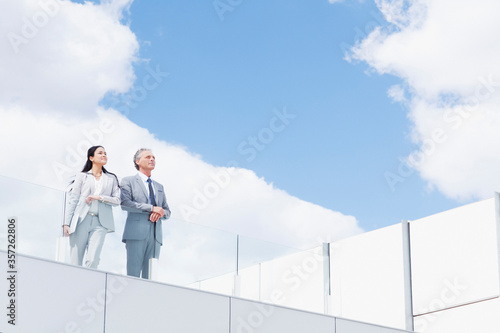 Businessman and businesswoman on balcony