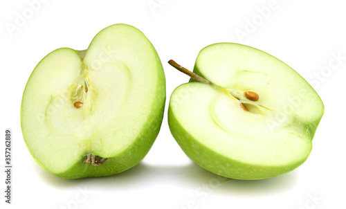two half of green apple isolated over white background