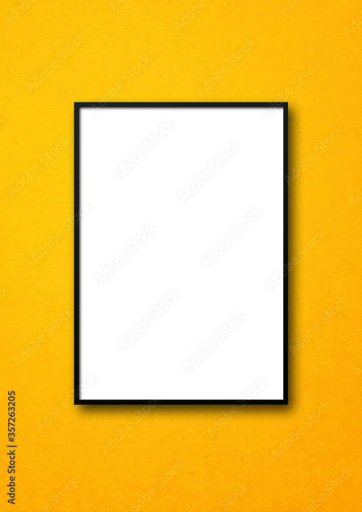 Black picture frame hanging on a yellow wall Black picture frame hanging on a yellow wall