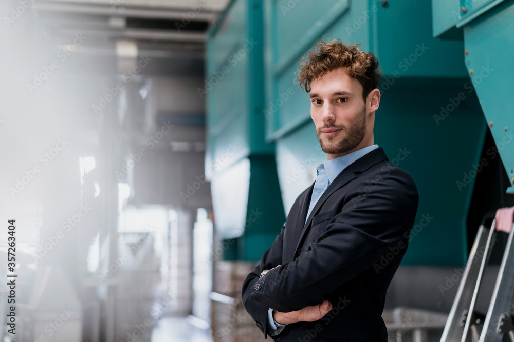 Portrait of a confident young businessman in a factory Portrait of a confident young businessman in a factory
