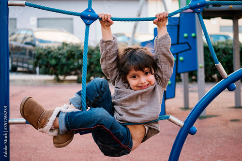 Girl on climbing net in playground