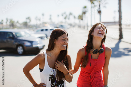 Laughing women walking outdoors