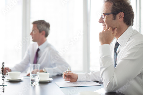 Businessmen sitting in meeting © Paul Bradbury/KOTO