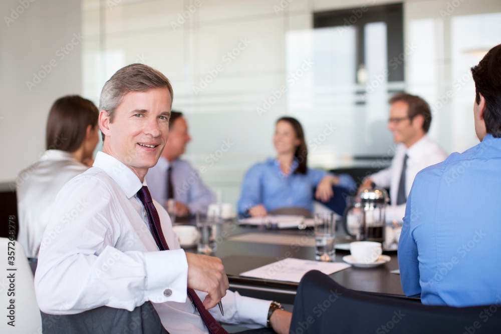 Businessman smiling in meeting Businessman smiling in meeting