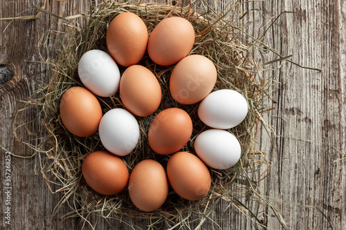 Raw hen eggs in a wicker basket, top view