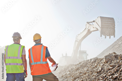 Wall Mural Workers watching digger in quarry
