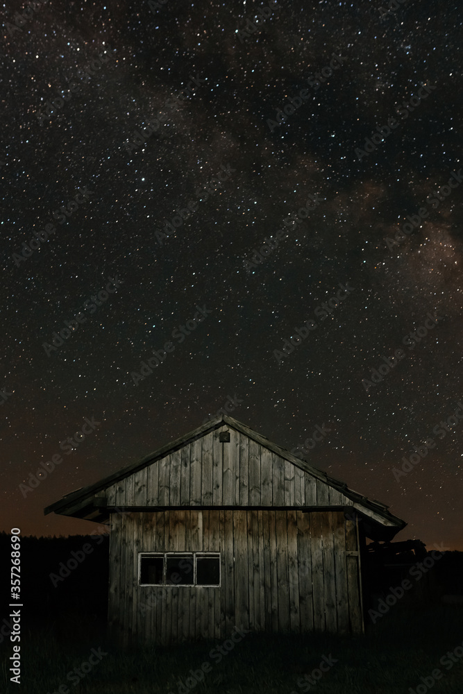 Small old wooden house on the background of the starry night. Starry night Small old wooden house on the background of the starry night. Starry night