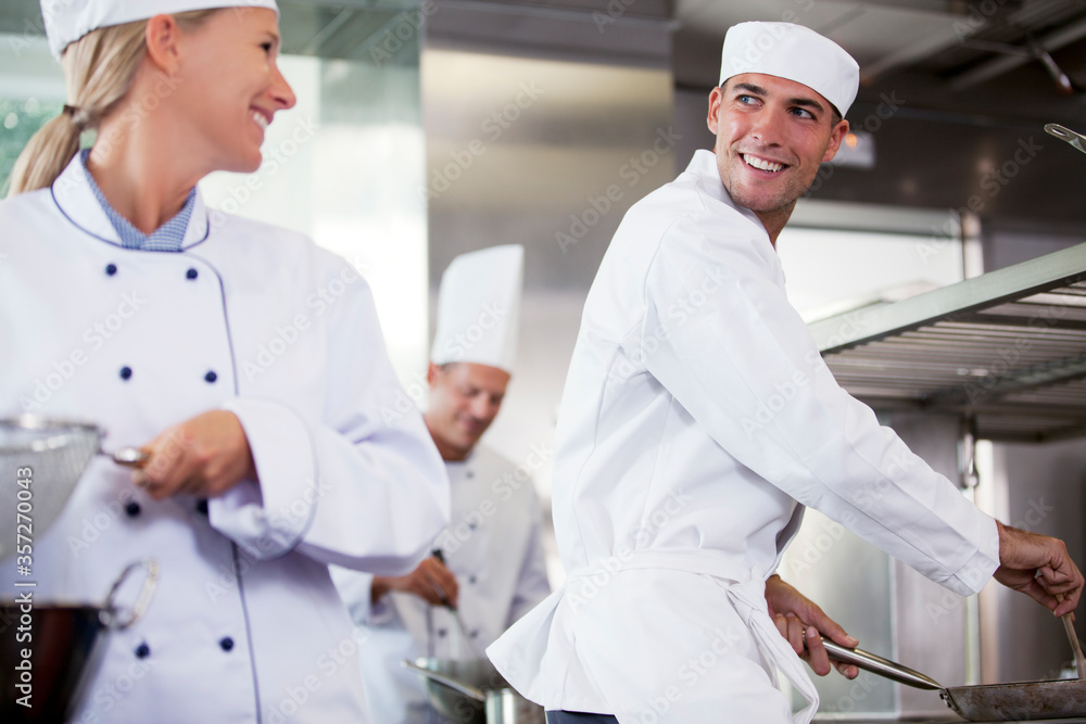 Obraz premium Chefs talking in restaurant kitchen