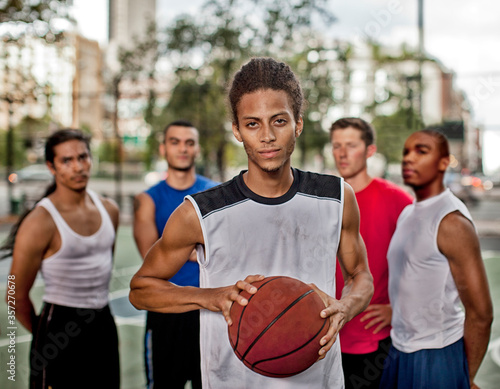 Men standing on basketball court