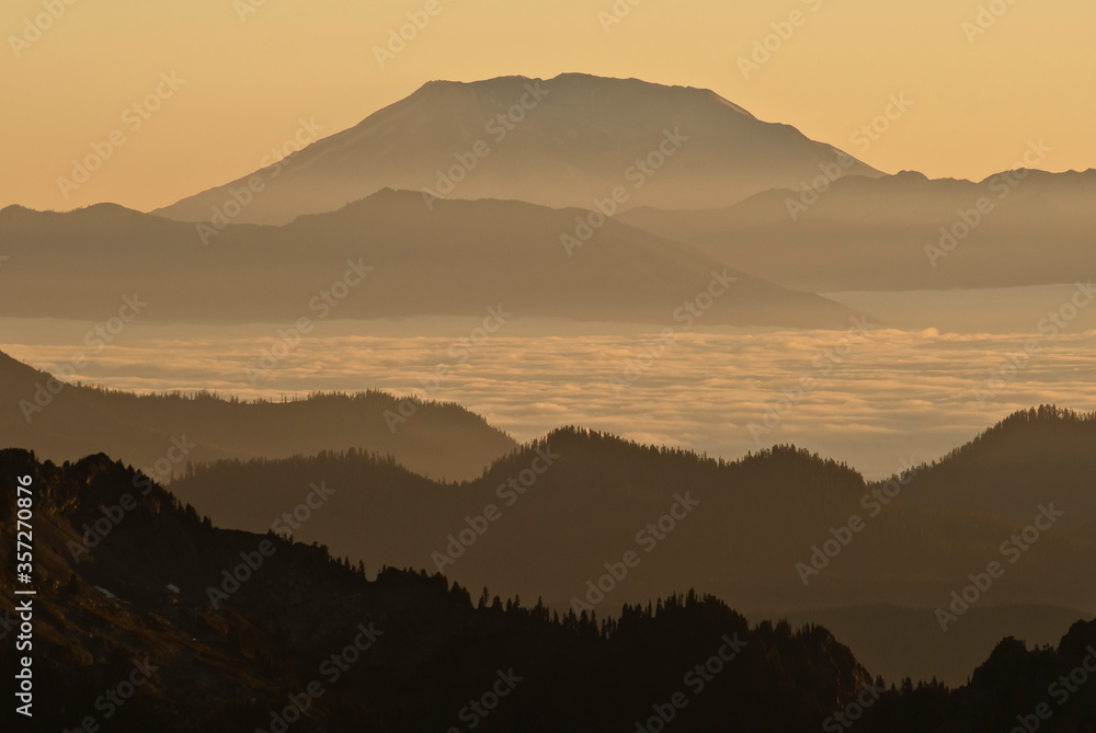 Silhouette of mountain over foggy landscape