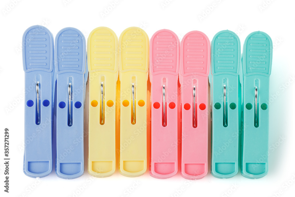 Color plastic clothespins isolated on white background. Plastic clips. Close-up.