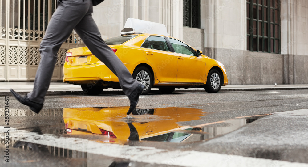 Businessman crossing city street Businessman crossing city street