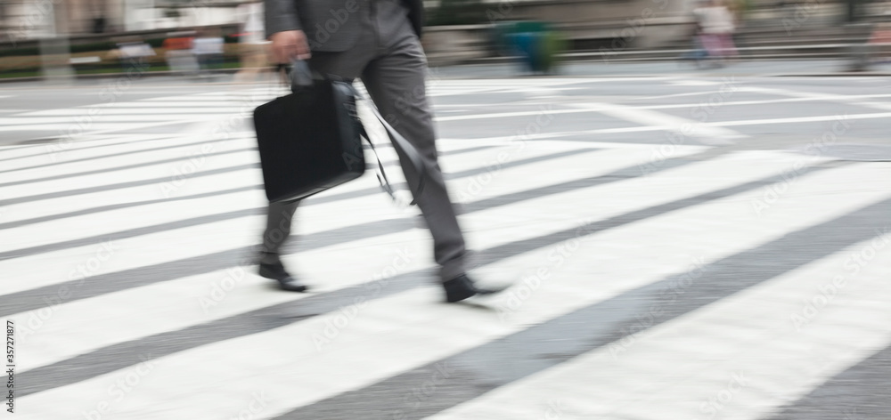 Businessman crossing city street