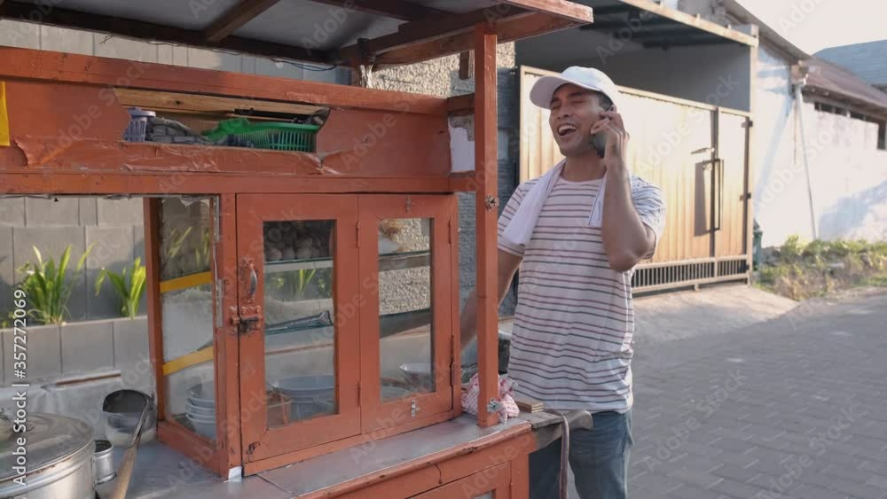 man selling bakso in the carts. indonesia street food. small business entrepreneur man selling bakso in the carts. indonesia street food. small business entrepreneur