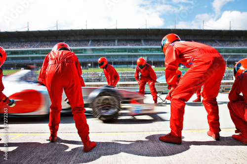 Racing team working at pit stop photo