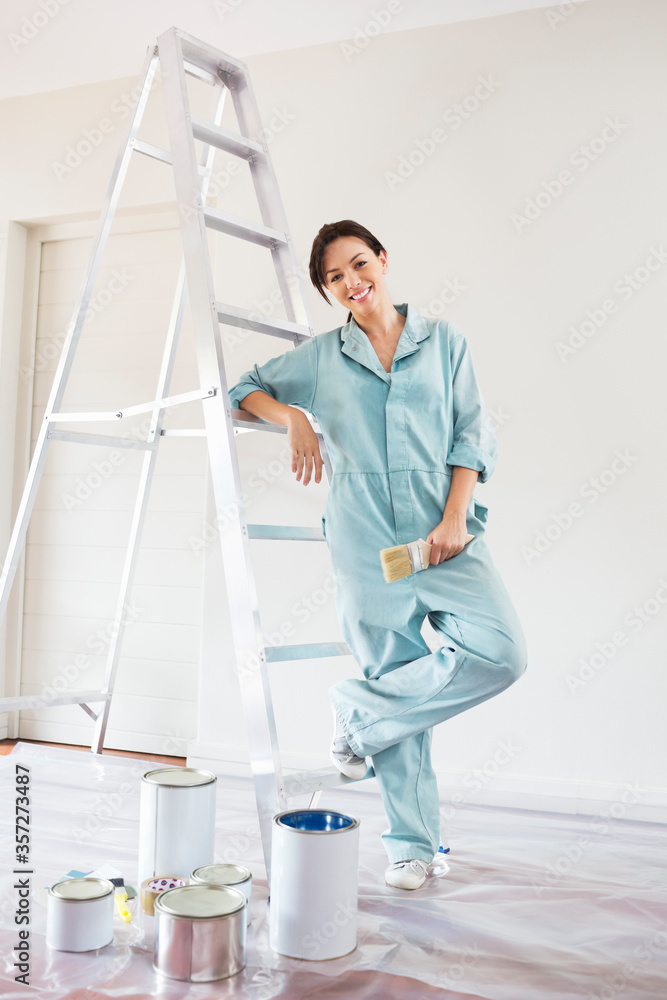 Woman smiling and painting room