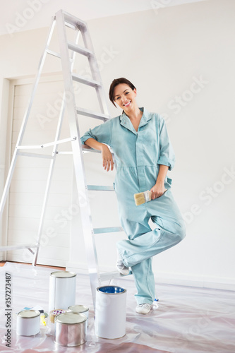 Woman smiling and painting room